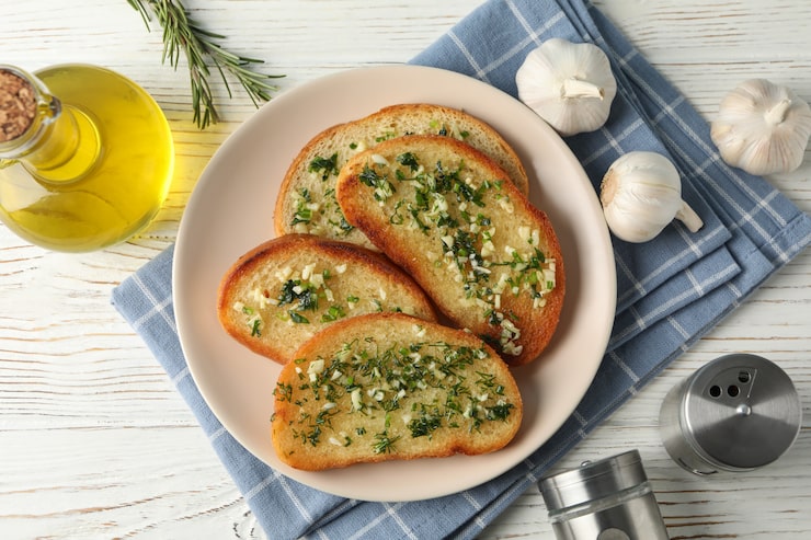plate-with-toasted-garlic-bread-oil-wooden_185193-9642 (1)