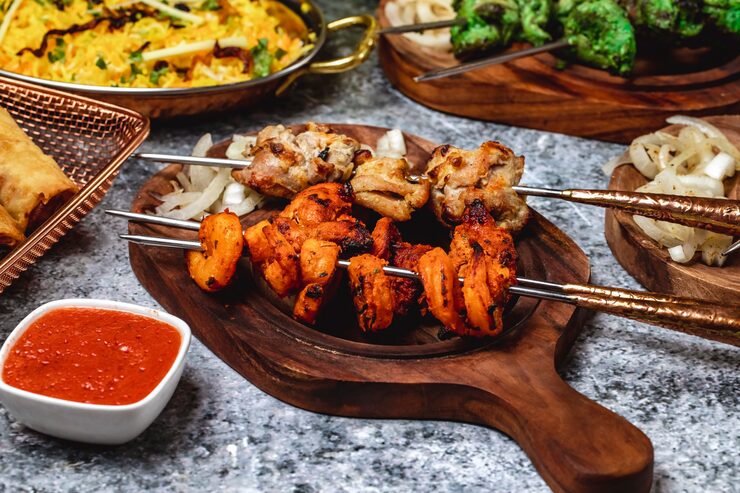 side-view-lamb-kebab-with-shrimps-griled-onion-sauce-board_141793-4983